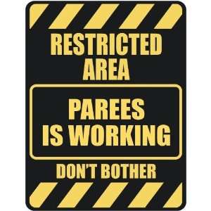   RESTRICTED AREA PAREES IS WORKING  PARKING SIGN