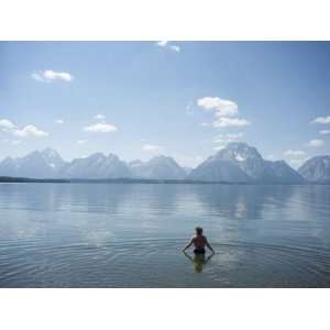 Woman Wades in Lake with Tetons in Distance, Grand Teton National Park 