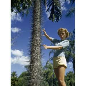  Woman Gestures in Mock Pain Toward Thorny Bark of Spiny Club 