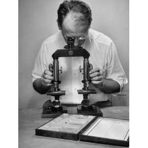  A Man Looking Through a Microscope to Match Up Fibers for 