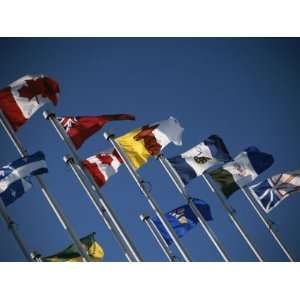  Flags of Canadian Provinces Waving on Flag Poles against a 