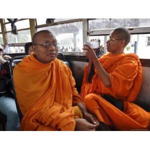  A Buddhist Monk Uses His Camcorder on a Bus in Vientiane 