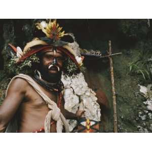  Elaborate Headdress and Boar Tusks Decorate the Face of a 