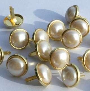 12 pieces of 12mm round white pearl brads with gold trim. Great for 
