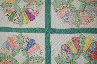   and hand quilted, with green print accents and a nice petal border
