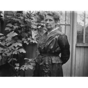  A Woman Standing in Front of a Wooden Shed in the Garden 